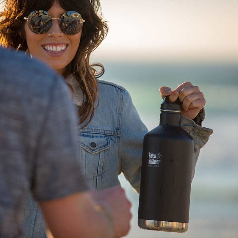 64oz-classic-with-loop-cap-c5 64oz_insulated_classic_black_beach_girl_hand_square.jpg